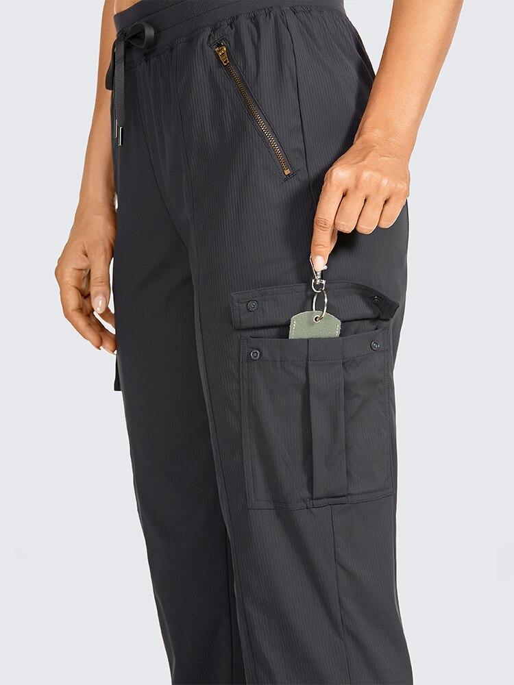 Lightweight drawstring athletic cargo pants for women, featuring zipper pockets and an elastic waist, ideal for travel and workouts.