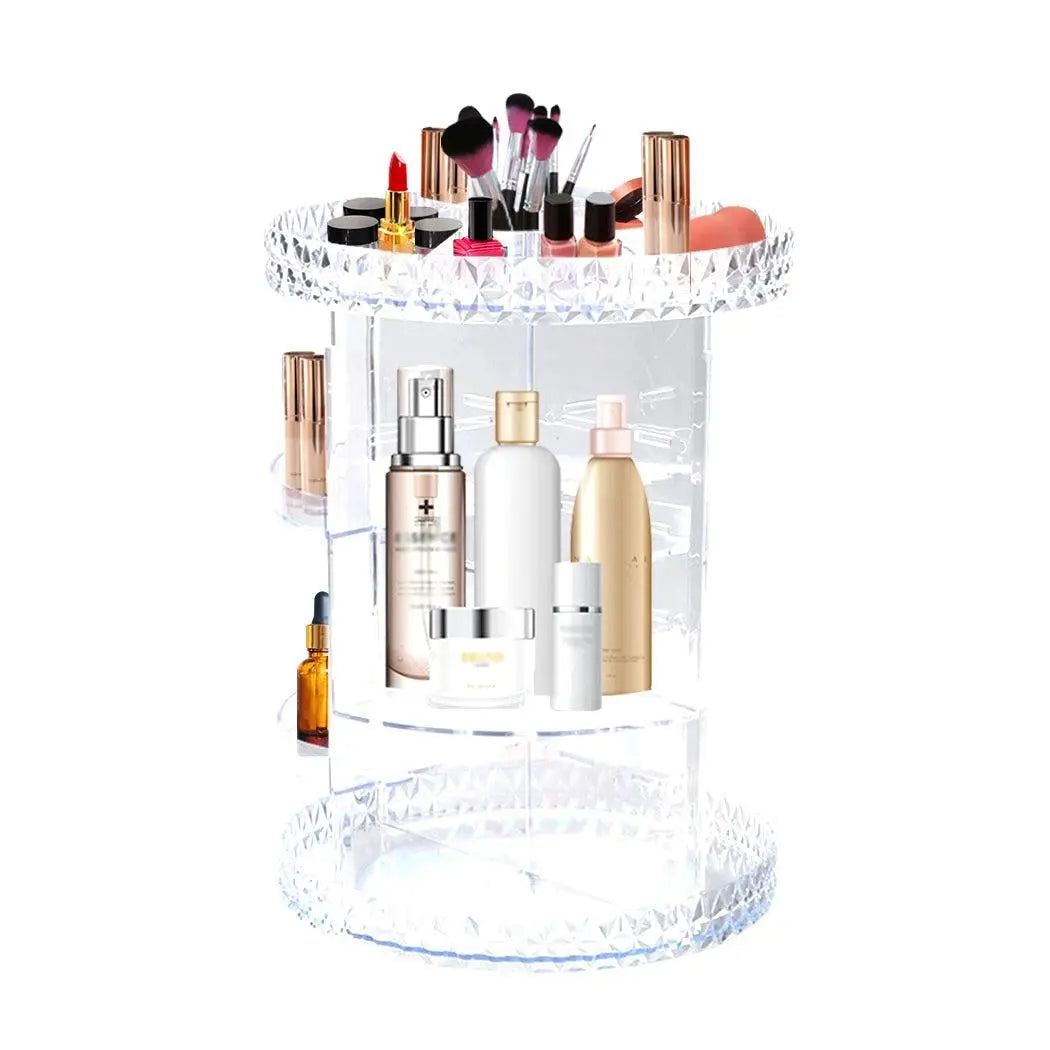 A clear acrylic rotating cosmetic organizer with a diamond shape design, featuring three tiers for makeup storage.