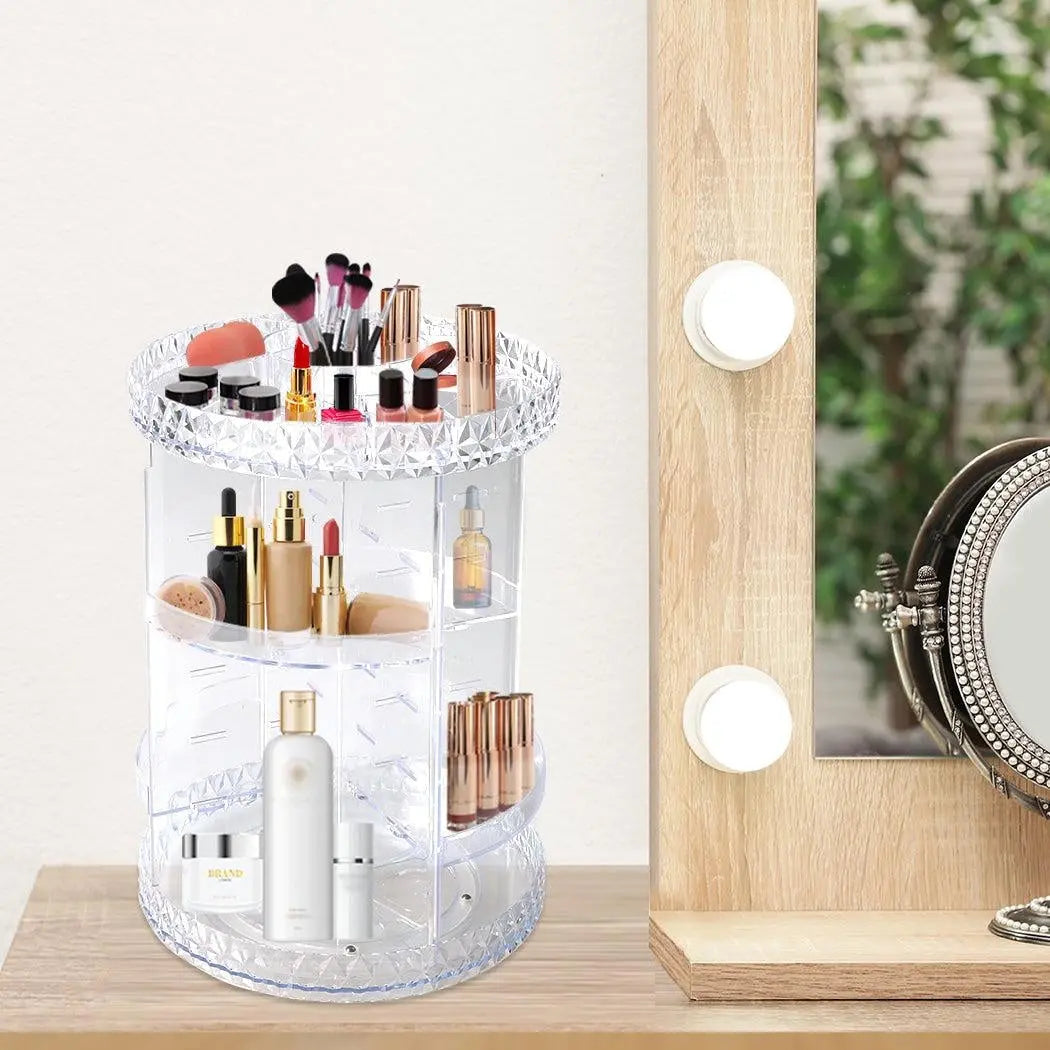 A clear acrylic rotating cosmetic organizer with a diamond shape design, featuring three tiers for makeup storage.