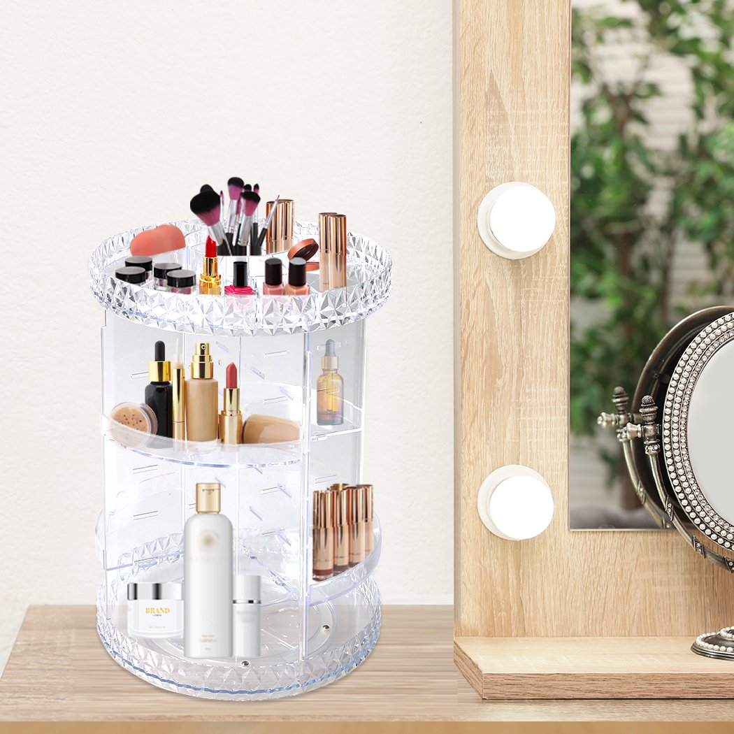 A clear acrylic rotating cosmetic organizer with a diamond shape design, featuring three tiers for makeup storage.
