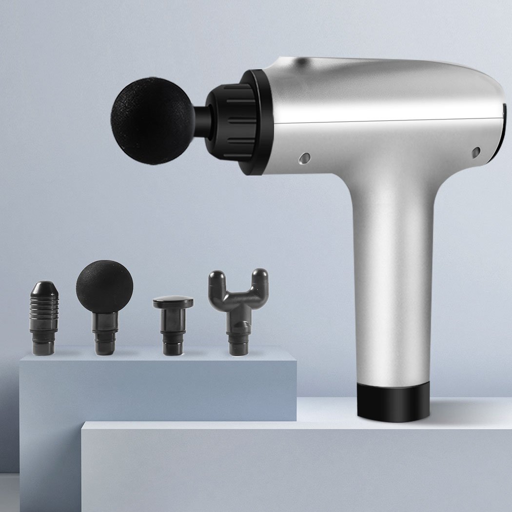 A sleek silver massage gun with four interchangeable heads, designed for deep tissue percussion massage and muscle relaxation.