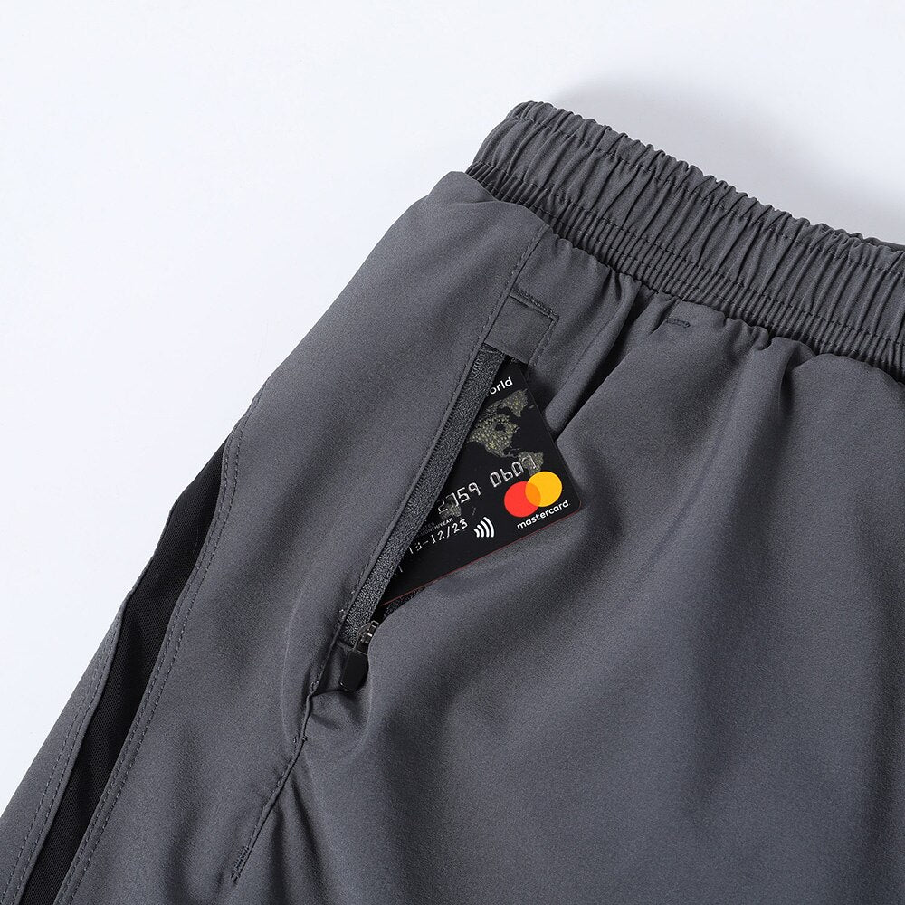 Men's 7 Inch Running Shorts in blue, gray, and black, featuring a 2-in-1 design and a pocket for essentials.