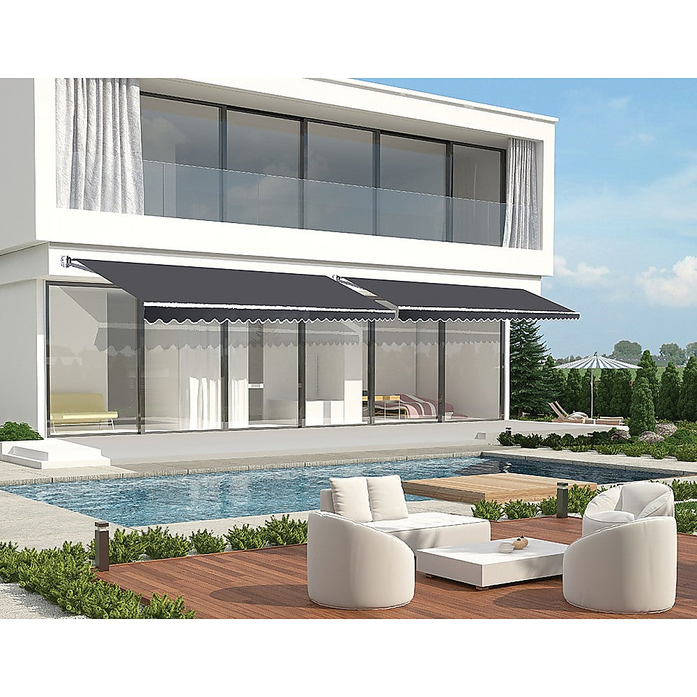Motorised Outdoor Folding Arm Awning in grey, showcasing its retractable design and scalloped trim, perfect for patios and balconies.