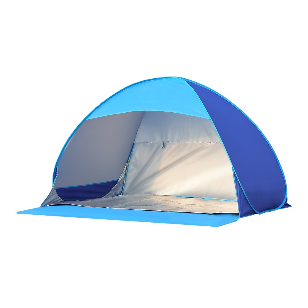 Mountview Pop Up Tent set up on a beach, spacious enough for 2-3 people, featuring a blue color and surrounded by sand and beach scenery.