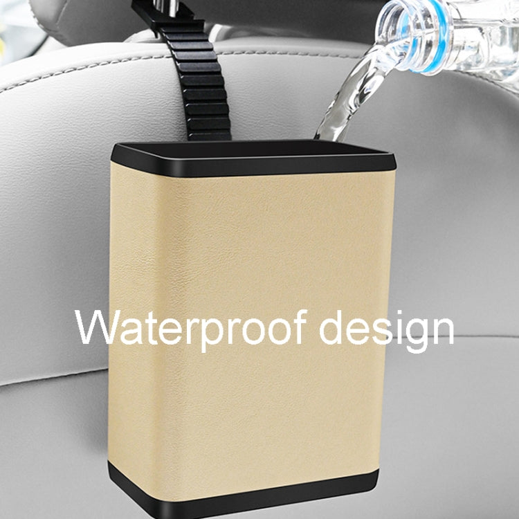 Multifunctional car dustbin hanging on a car seat, made of ABS and leather, designed for storage and waste disposal.