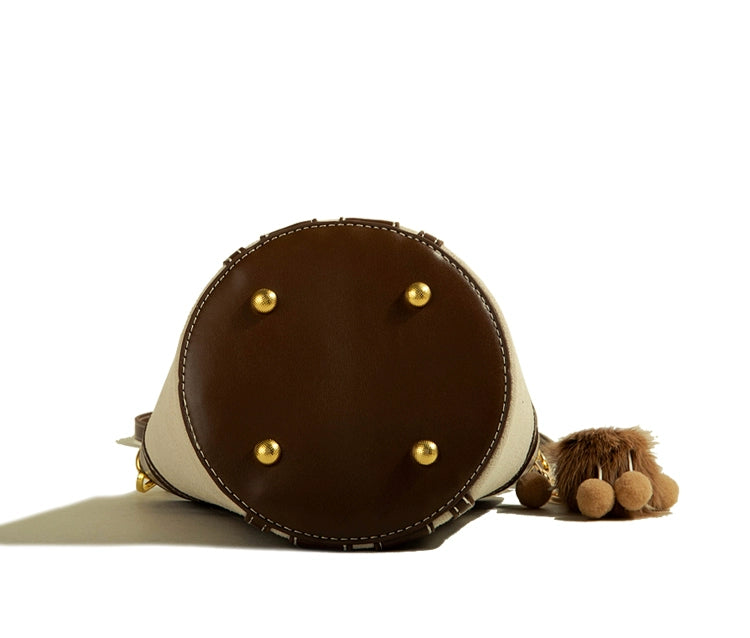 Muzikai Genuine Goods Bucket Bag showcasing advanced texture and stylish design, perfect for hand-carrying.