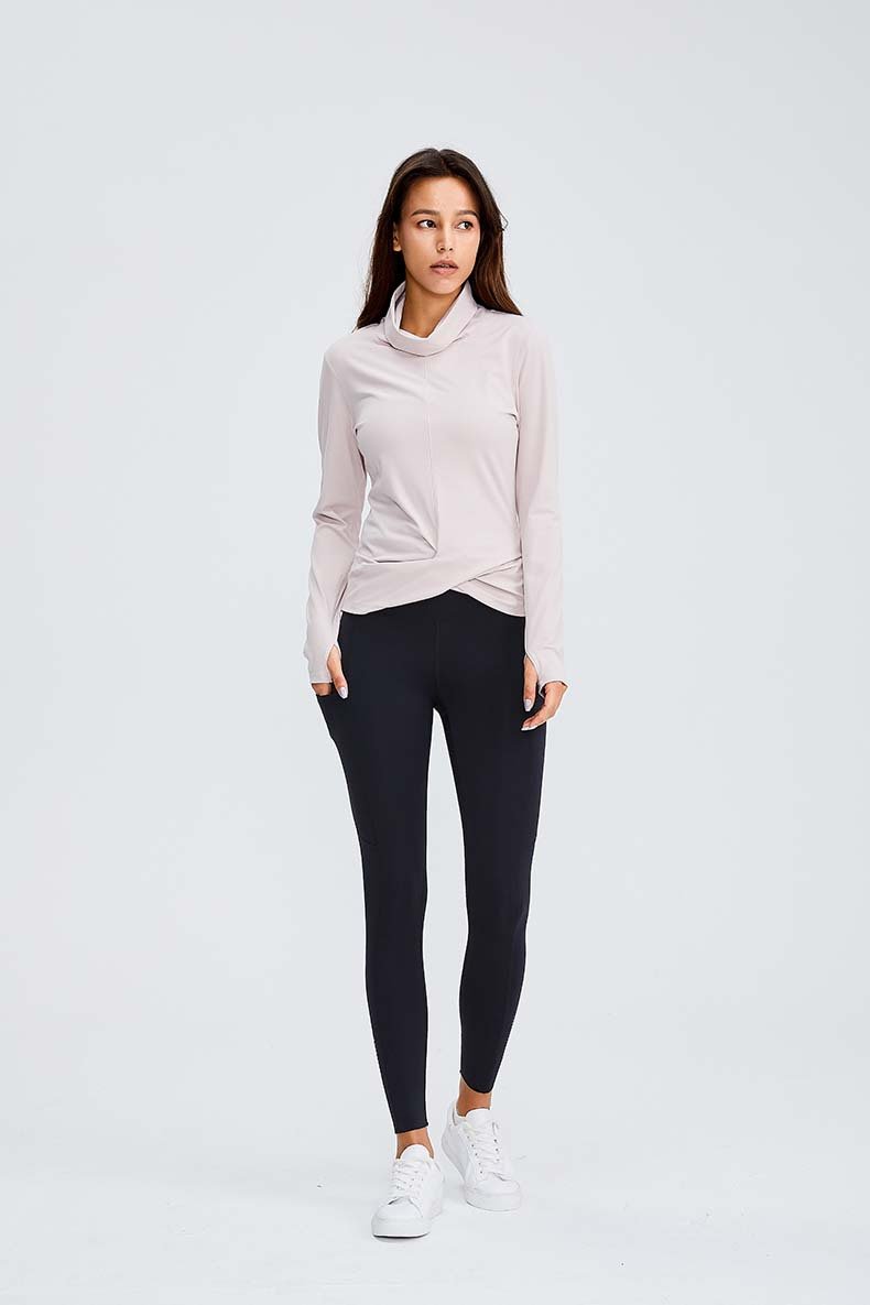Women wearing a Naked Feel Turtle Neck Yoga Long Sleeve Shirt in a fitness setting, showcasing its stylish design and thumb hole feature.