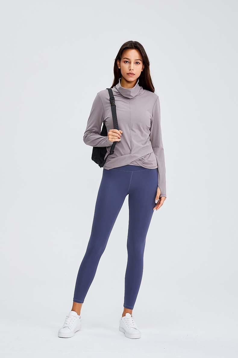 Women wearing a Naked Feel Turtle Neck Yoga Long Sleeve Shirt in a fitness setting, showcasing its stylish design and thumb hole feature.