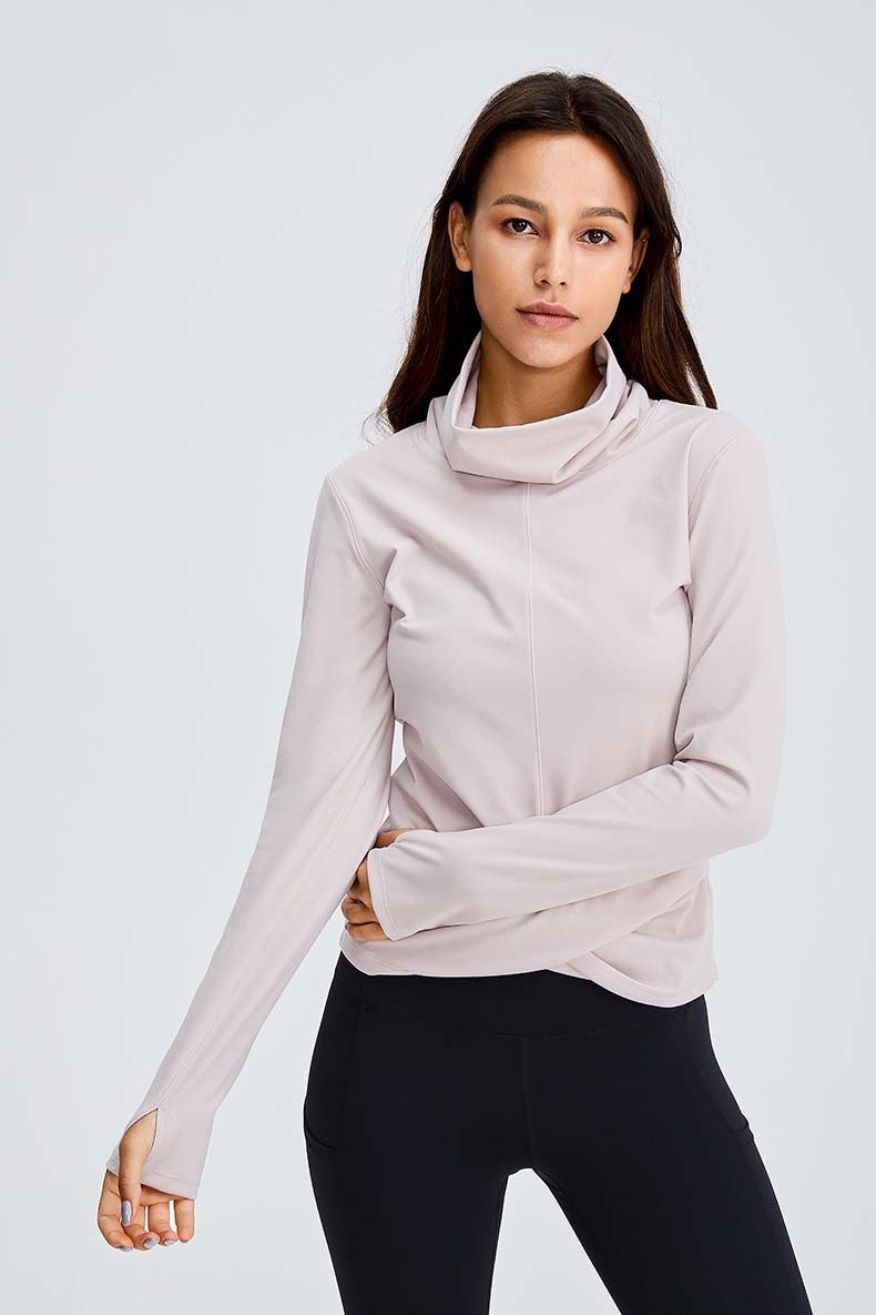 Women wearing a Naked Feel Turtle Neck Yoga Long Sleeve Shirt in a fitness setting, showcasing its stylish design and thumb hole feature.