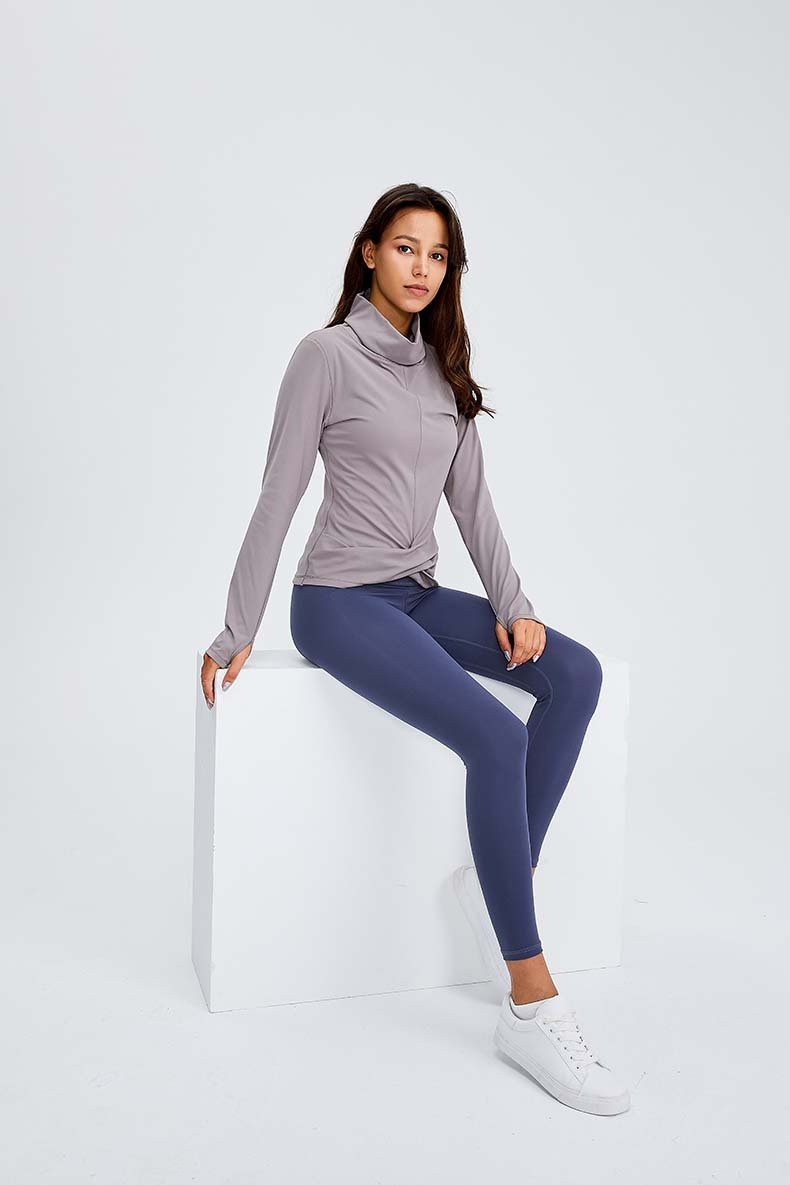 Women wearing a Naked Feel Turtle Neck Yoga Long Sleeve Shirt in a fitness setting, showcasing its stylish design and thumb hole feature.