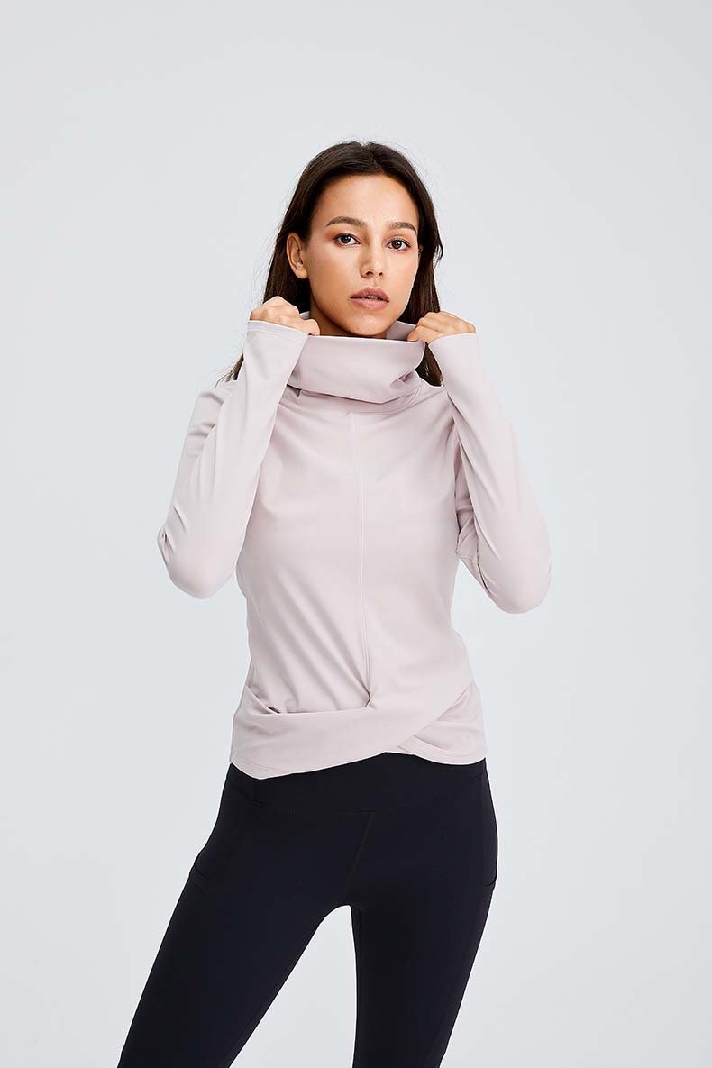 Women wearing a Naked Feel Turtle Neck Yoga Long Sleeve Shirt in a fitness setting, showcasing its stylish design and thumb hole feature.