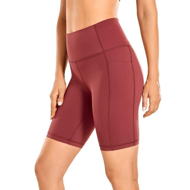 A pair of women's high-waisted biker shorts in solid color with pockets, designed for comfort and active wear.
