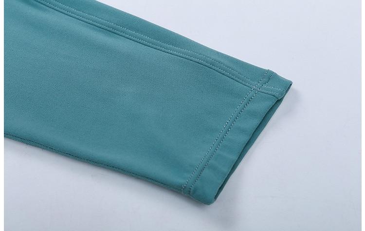 A woman wearing a lightweight, long-sleeved yoga shirt made from naked-feel fabric, ideal for workouts.