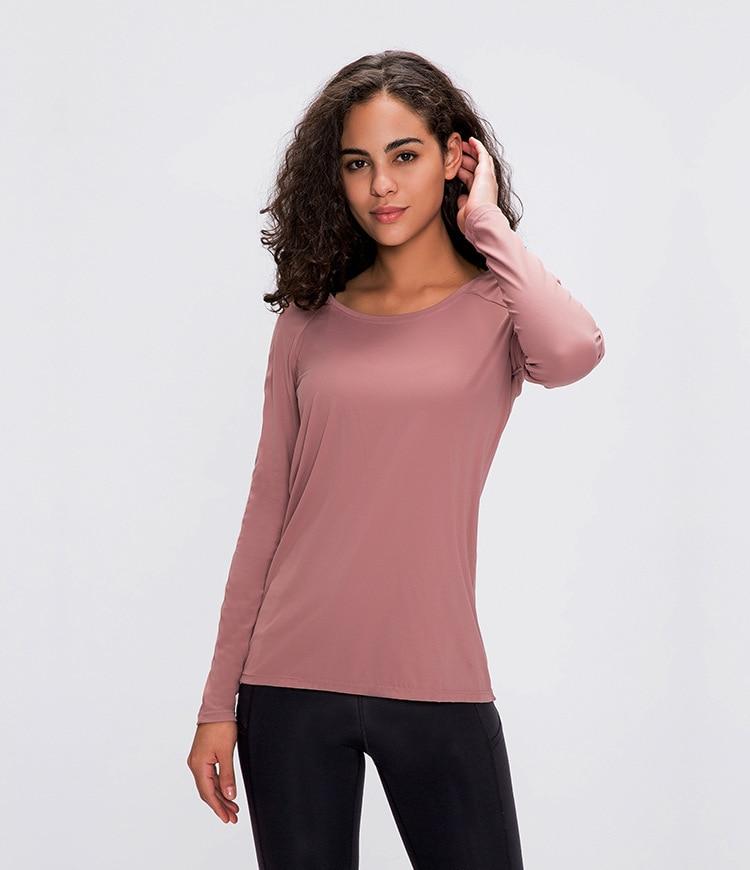 A woman wearing a lightweight, long-sleeved yoga shirt made from naked-feel fabric, ideal for workouts.