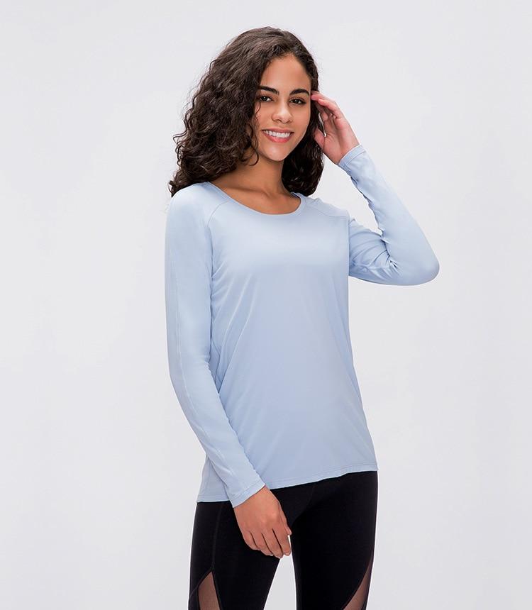 A woman wearing a lightweight, long-sleeved yoga shirt made from naked-feel fabric, ideal for workouts.