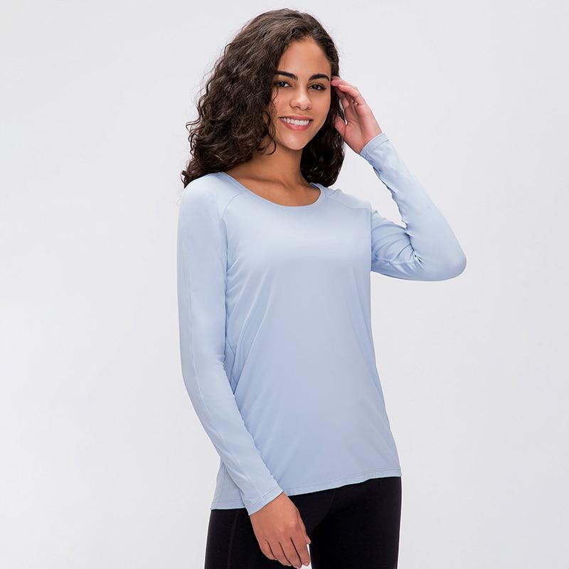 A woman wearing a lightweight, long-sleeved yoga shirt made from naked-feel fabric, ideal for workouts.