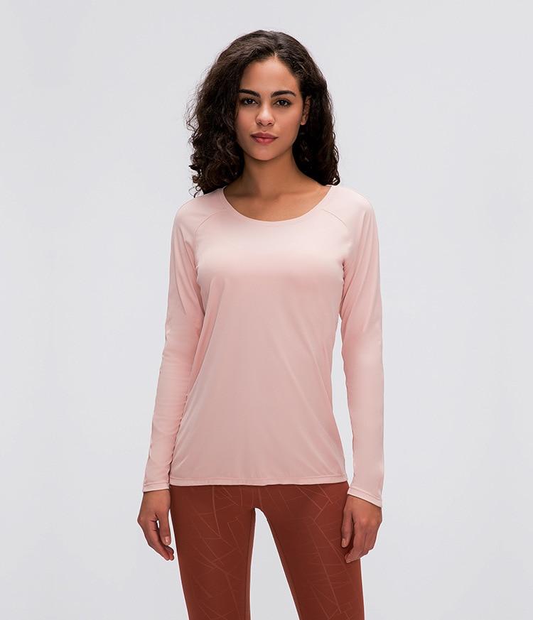 A woman wearing a lightweight, long-sleeved yoga shirt made from naked-feel fabric, ideal for workouts.