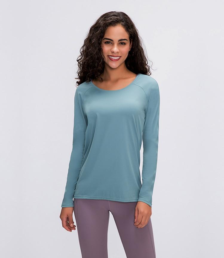 A woman wearing a lightweight, long-sleeved yoga shirt made from naked-feel fabric, ideal for workouts.