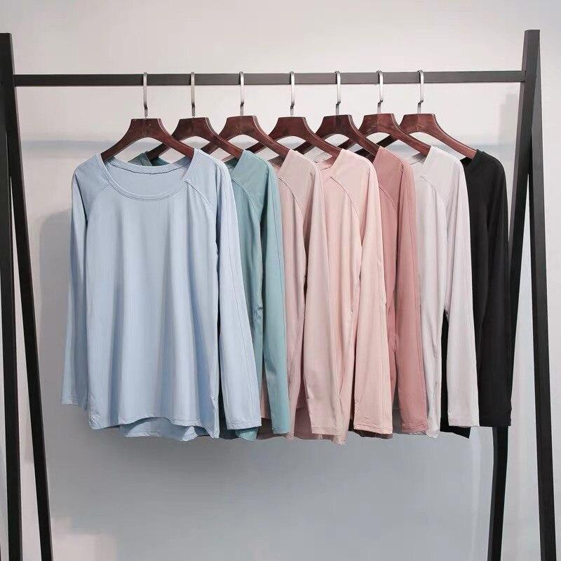 A woman wearing a lightweight, long-sleeved yoga shirt made from naked-feel fabric, ideal for workouts.