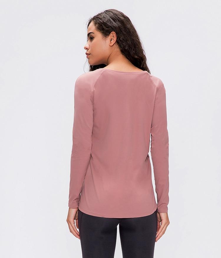 A woman wearing a lightweight, long-sleeved yoga shirt made from naked-feel fabric, ideal for workouts.