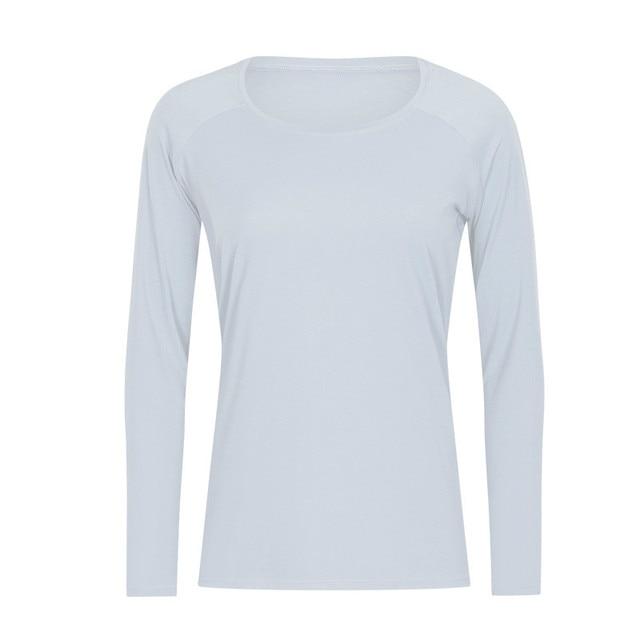 A woman wearing a lightweight, long-sleeved yoga shirt made from naked-feel fabric, ideal for workouts.