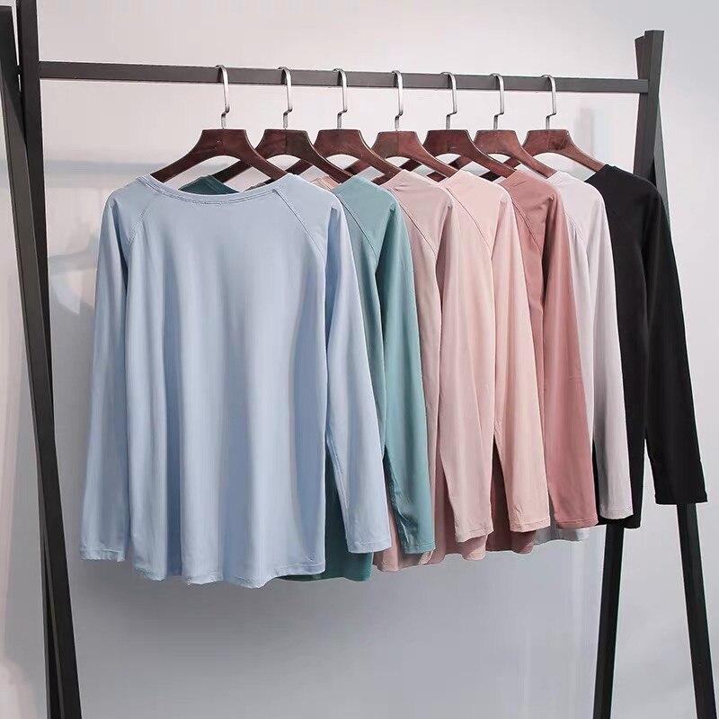 A woman wearing a lightweight, long-sleeved yoga shirt made from naked-feel fabric, ideal for workouts.