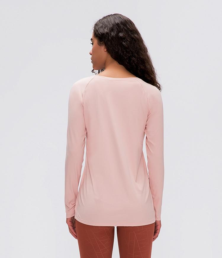 A woman wearing a lightweight, long-sleeved yoga shirt made from naked-feel fabric, ideal for workouts.