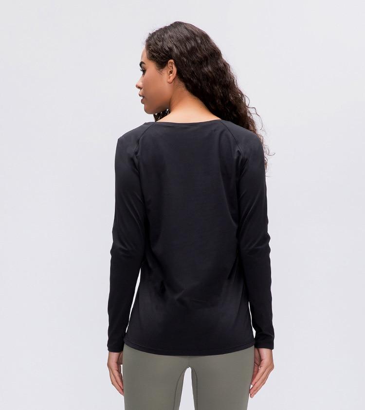 A woman wearing a lightweight, long-sleeved yoga shirt made from naked-feel fabric, ideal for workouts.