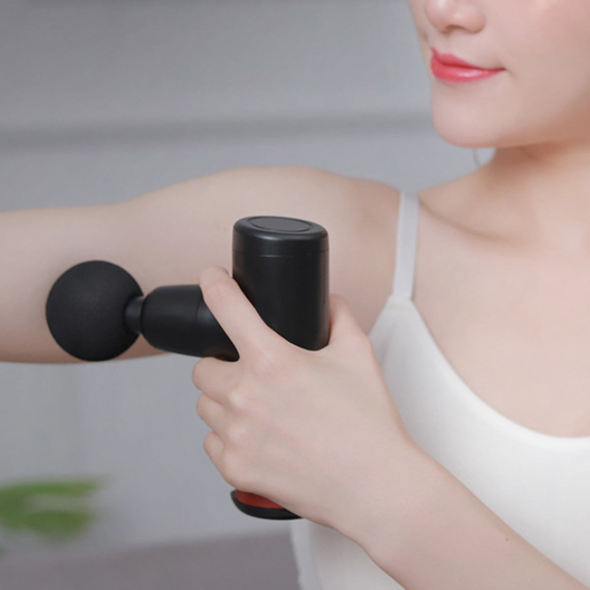 No More Sore Mini Massager and Muscle Toner in various colors, showcasing its compact design and interchangeable heads.