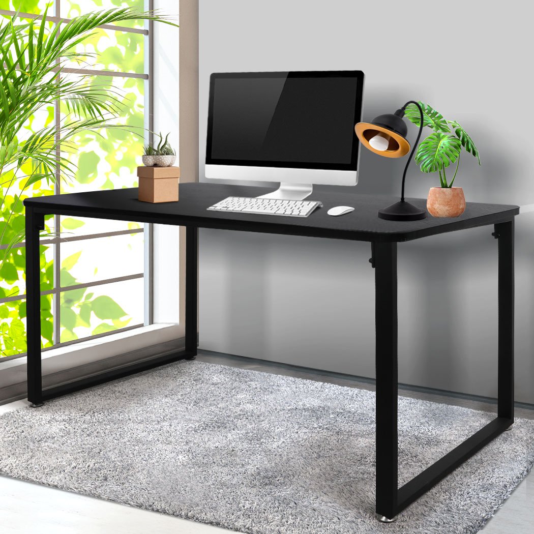 A modern black office desk with a spacious tabletop, sturdy steel frame, and anti-scratch feet pads, ideal for home or study use.