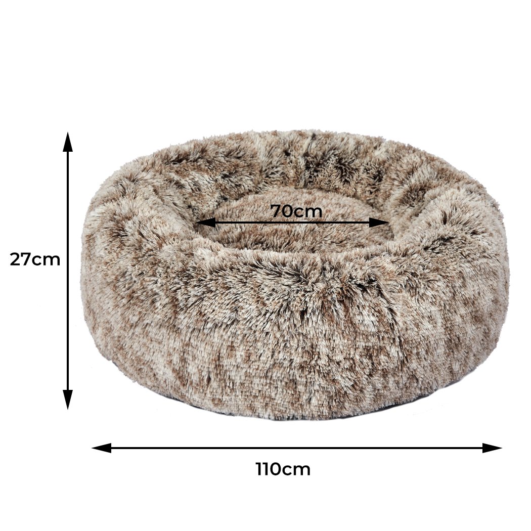 A cozy coffee-colored donut-shaped pet bed with plush material and raised rim, perfect for dogs and cats to relax and feel secure.