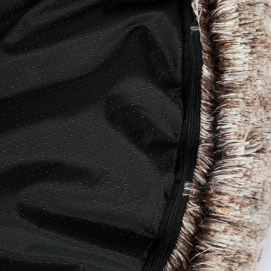 A cozy coffee-colored donut-shaped pet bed with plush material and raised rim, perfect for dogs and cats to relax and feel secure.