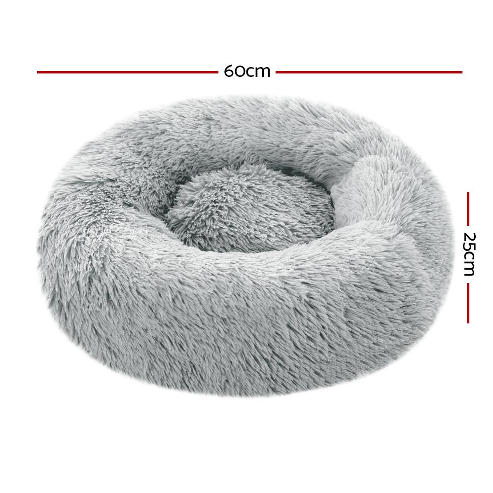 Light grey calming pet bed for small dogs and cats, featuring a soft surface and non-slip base, perfect for cozy sleeping.