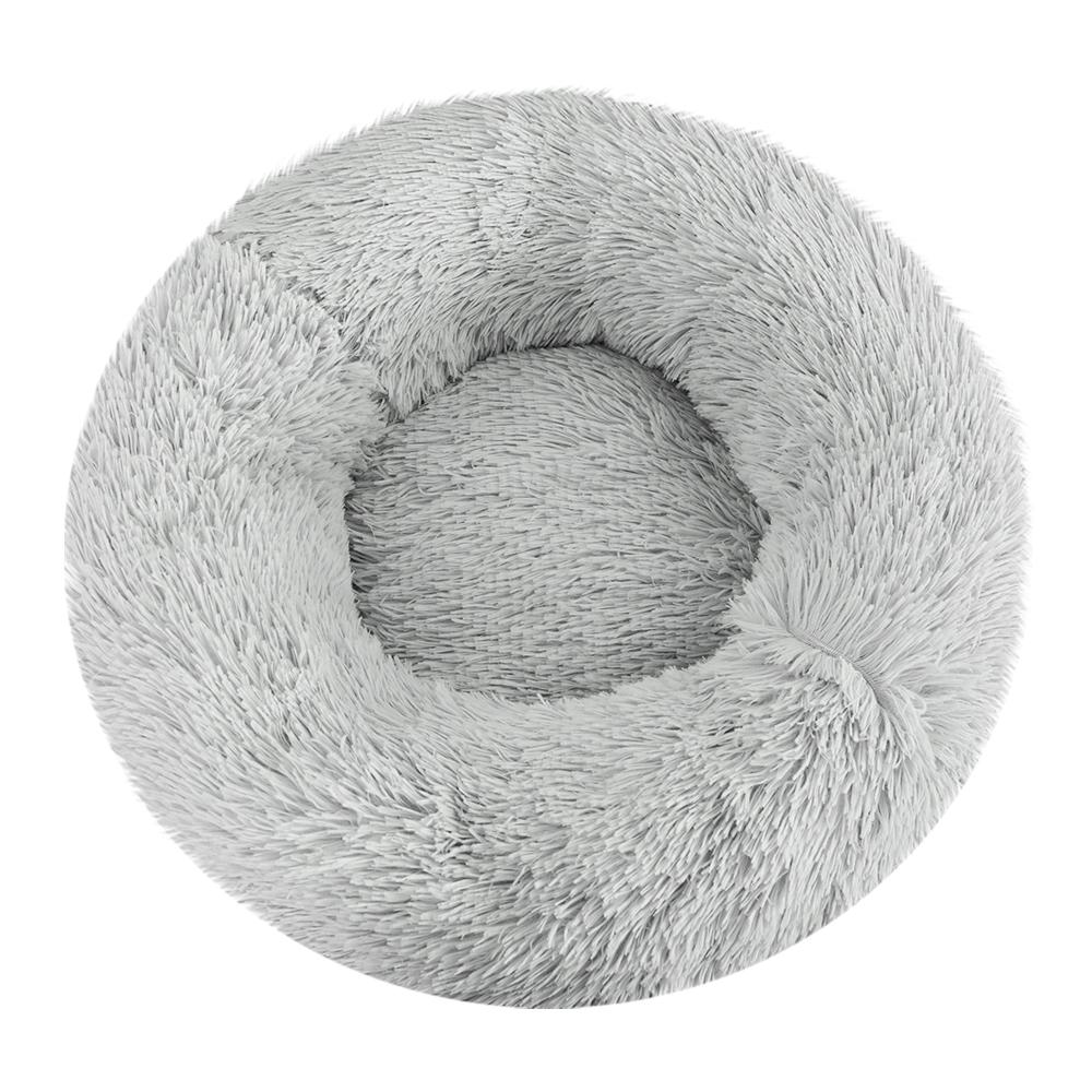 Light grey calming pet bed for small dogs and cats, featuring a soft surface and non-slip base, perfect for cozy sleeping.