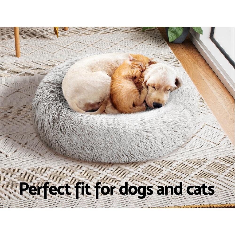 A cozy small 60cm pet bed for dogs and cats, featuring a soft white exterior and a non-slip base, perfect for a comfortable sleep.