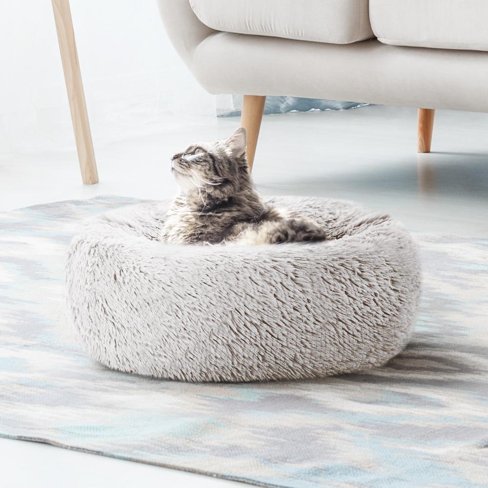 A cozy small 60cm pet bed for dogs and cats, featuring a soft white exterior and a non-slip base, perfect for a comfortable sleep.