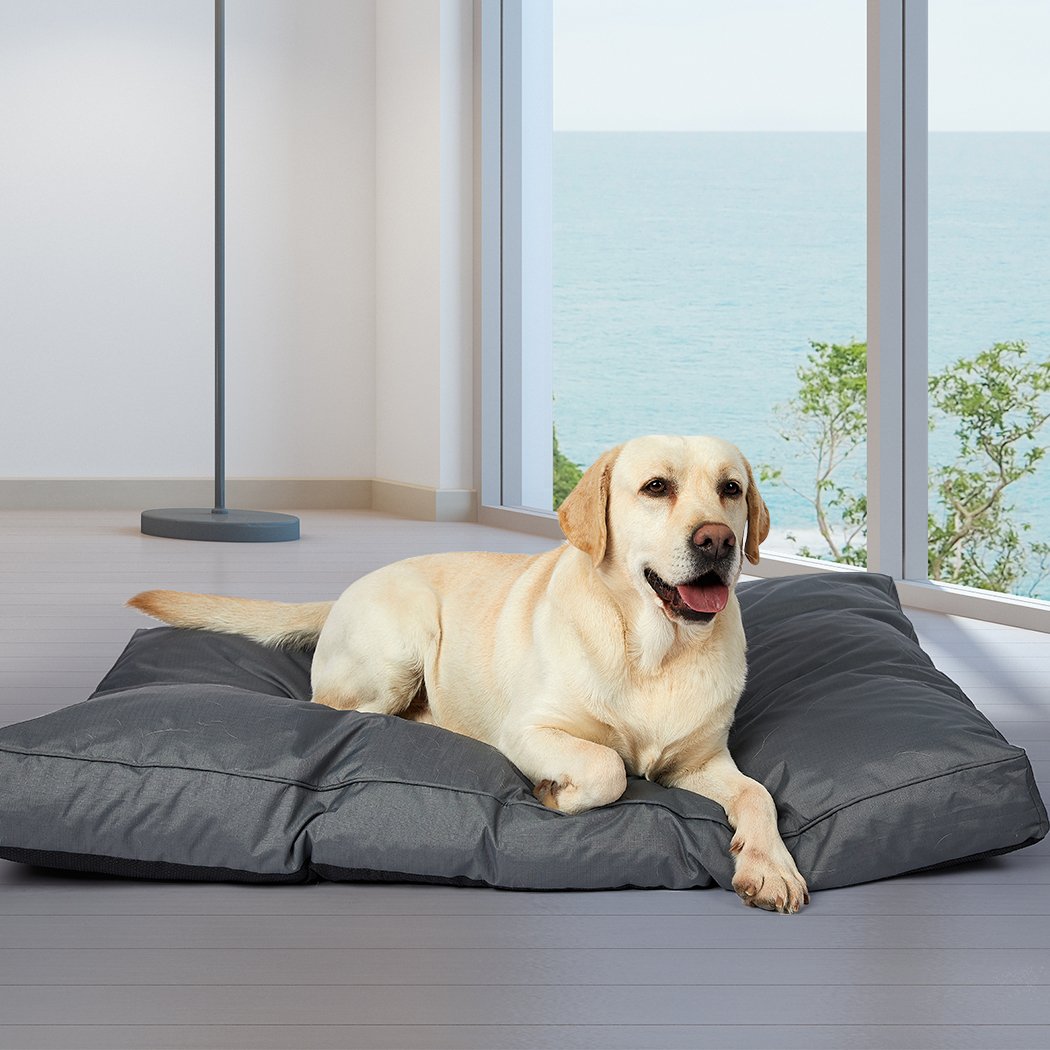 A cozy grey pet bed made of soft fleece and durable oxford fabric, featuring a plush design and ergonomic shape for ultimate comfort.
