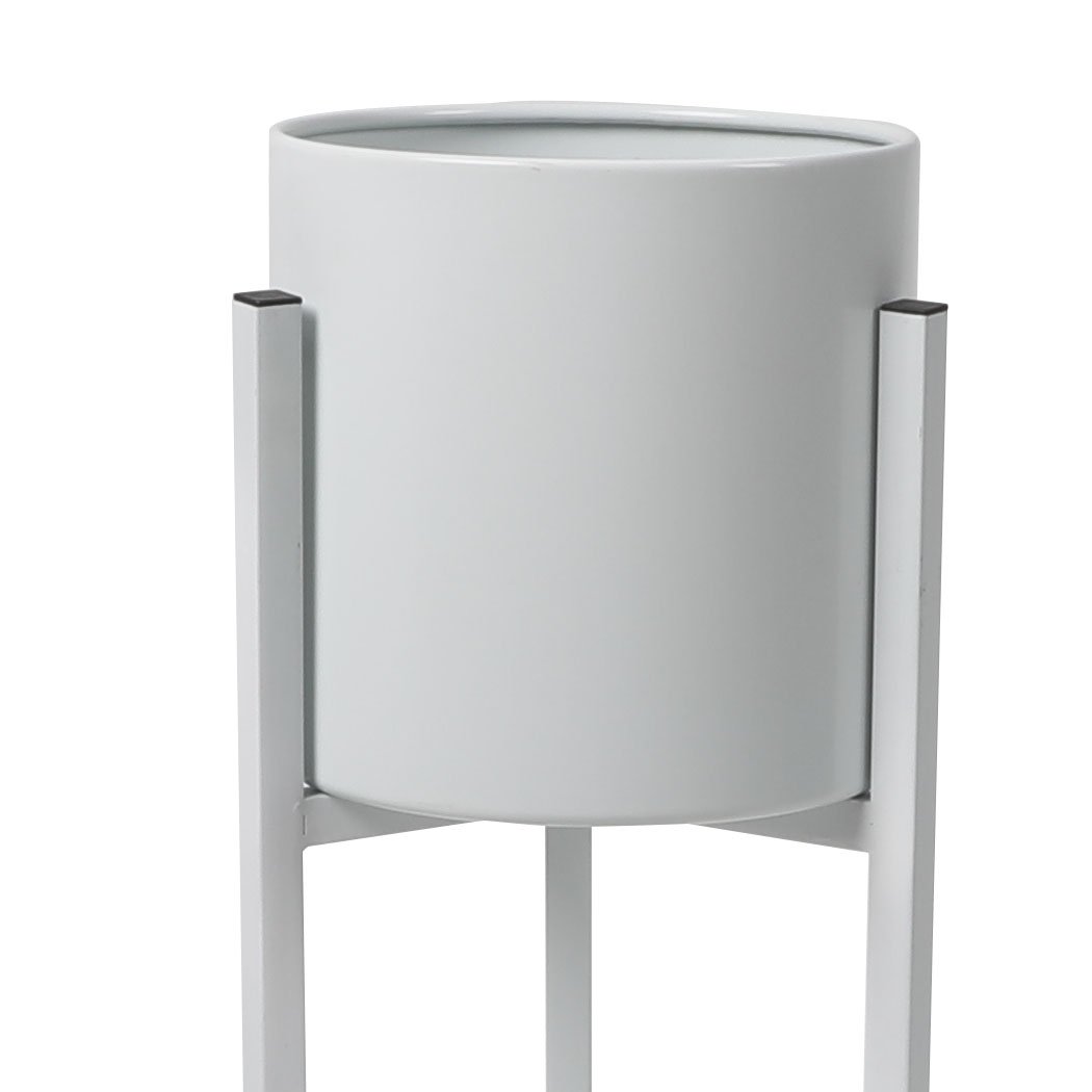 Elegant metal plant stand with a detachable pot, perfect for showcasing plants indoors and outdoors.