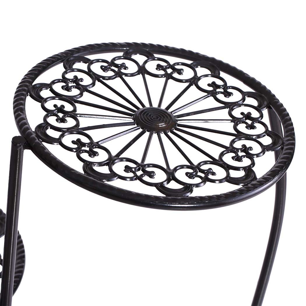 A stylish black metal plant stand with multiple tiers, showcasing various flower pots and greenery, suitable for indoor and outdoor use.