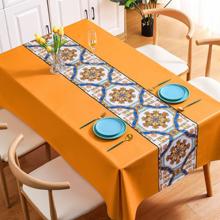 A stylish PVC waterproof oil-proof tablecloth featuring intricate embroidery, perfect for protecting dining tables.
