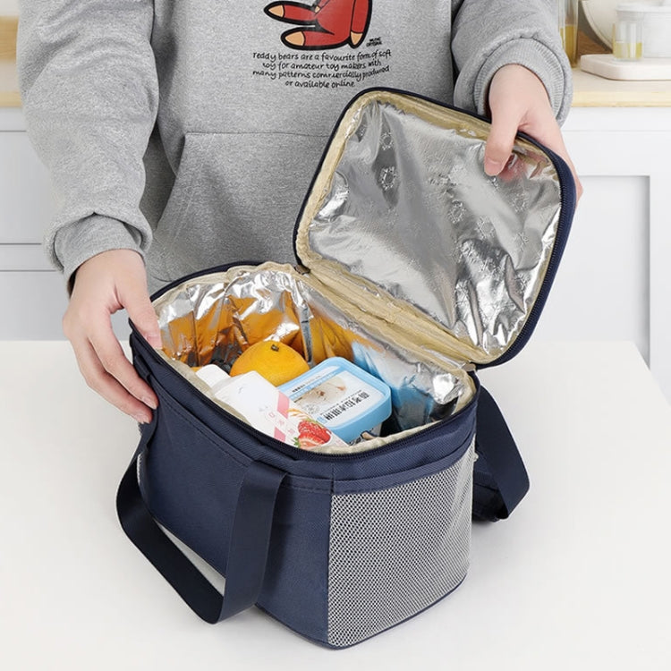 A stylish and functional reusable lunch bag featuring a waterproof Oxford cloth exterior, insulated aluminum lining, and comfortable hand strap, ideal for office, school, and outdoor use.