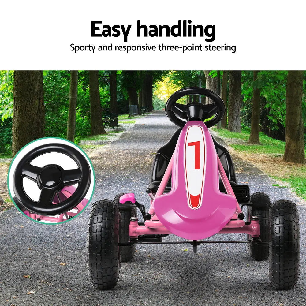 Rigo Kids Pedal Go Kart in vibrant pink color, featuring a sturdy steel frame, adjustable seat, and large rubber tyres for a smooth ride.