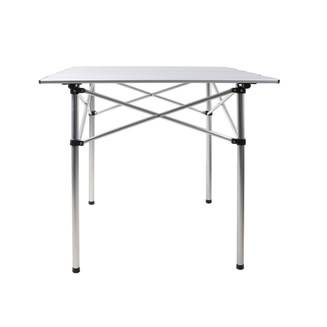 A lightweight and portable Roll Up Camping Table made of aluminium, set up outdoors with food and drinks on it, showcasing its sturdy design and anti-slip feet.