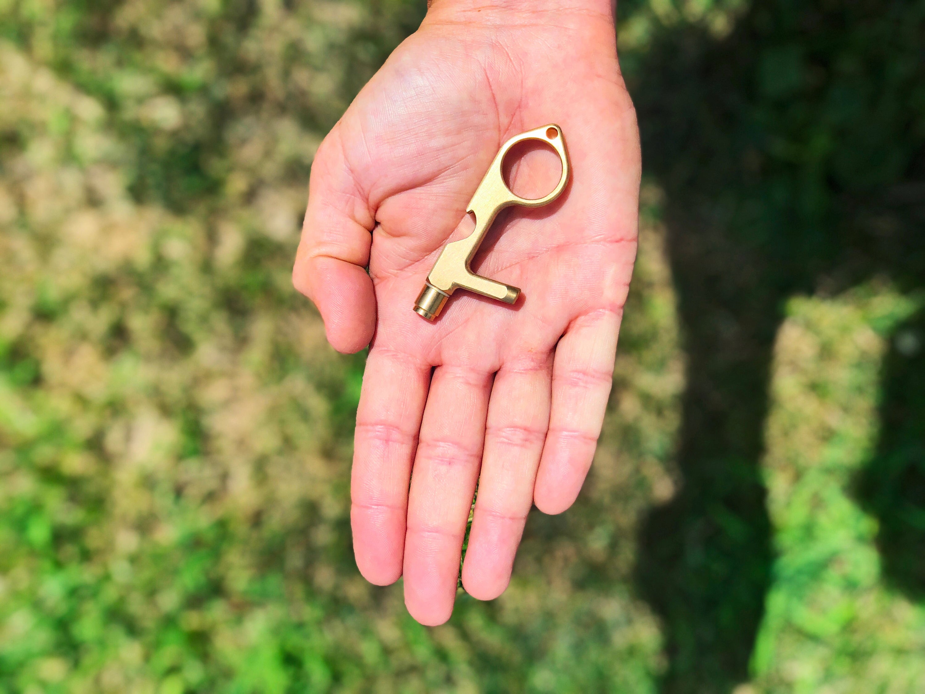 Safe Key Contact-Less LED Keychain Multi-Tool in Rose Gold, showcasing its ergonomic design and multiple functionalities.