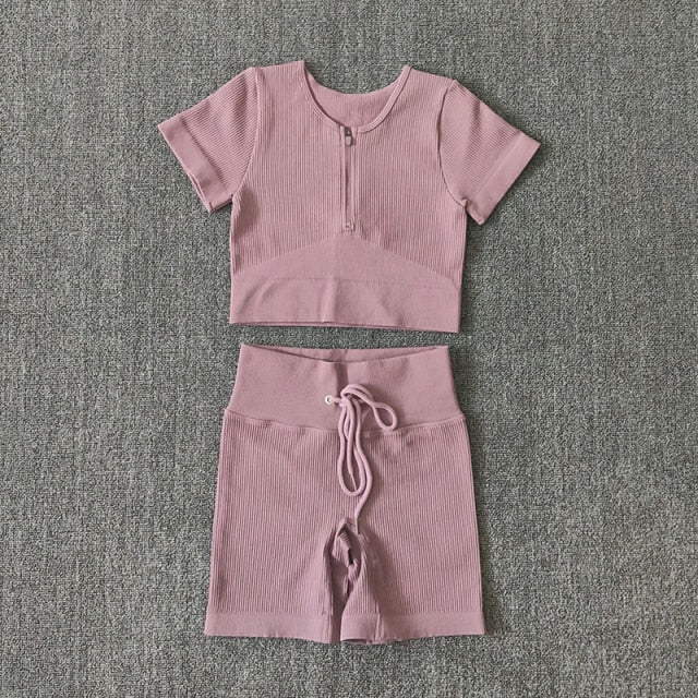 Seamless Yoga Set for women featuring a short sleeve crop top and drawstring sports shorts in various colors.