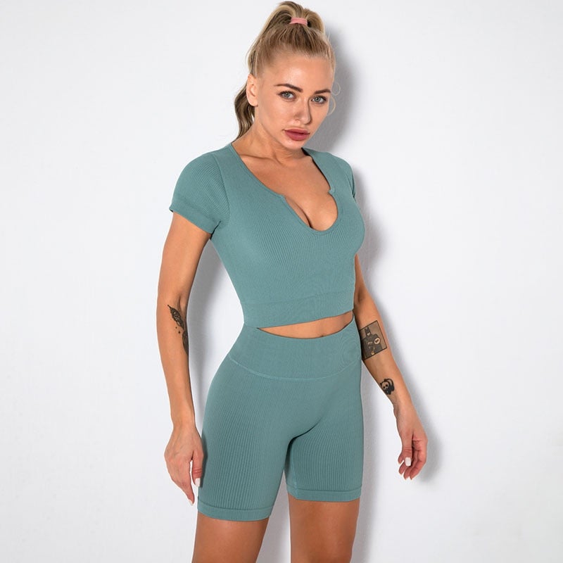 A stylish Seamless Yoga Set for women featuring a short sleeve crop top and high-waisted shorts in solid and striped patterns, perfect for workouts.