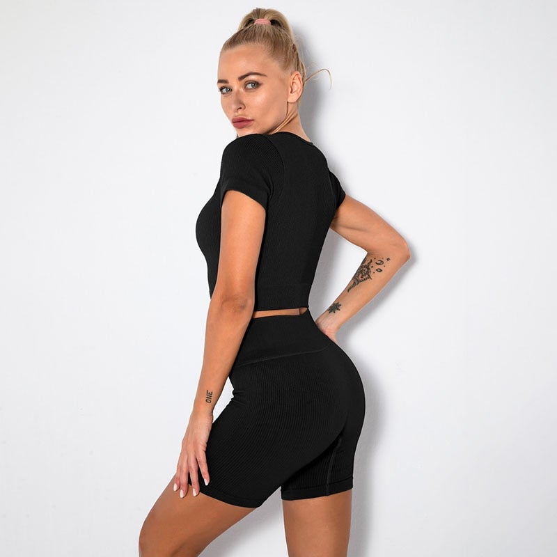 A stylish Seamless Yoga Set for women featuring a short sleeve crop top and high-waisted shorts in solid and striped patterns, perfect for workouts.