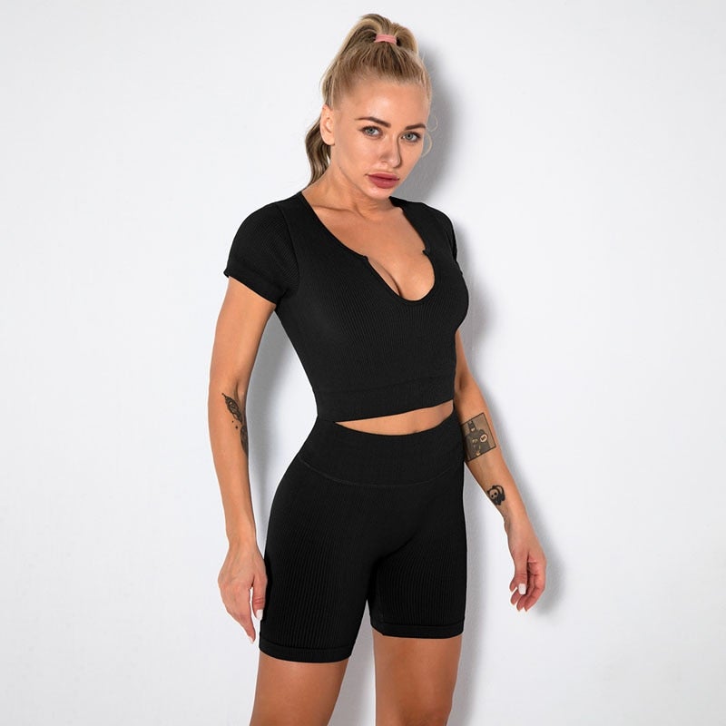 A stylish Seamless Yoga Set for women featuring a short sleeve crop top and high-waisted shorts in solid and striped patterns, perfect for workouts.