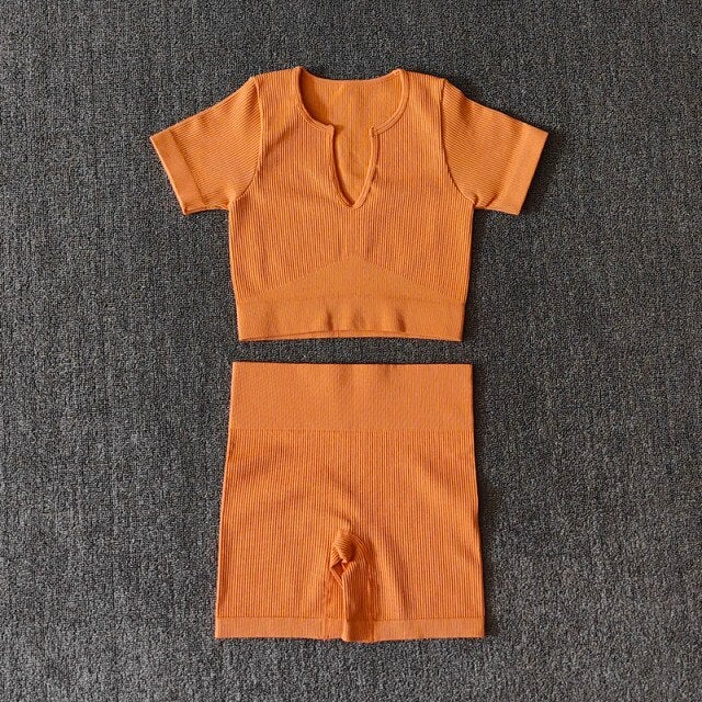 A stylish Seamless Yoga Set for women featuring a short sleeve crop top and high-waisted shorts in solid and striped patterns, perfect for workouts.