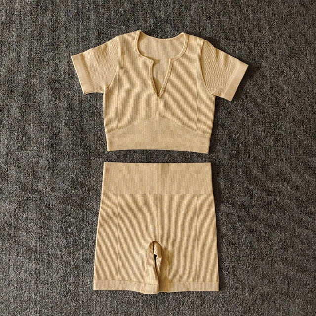 A stylish Seamless Yoga Set for women featuring a short sleeve crop top and high-waisted shorts in solid and striped patterns, perfect for workouts.